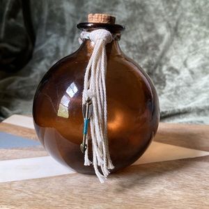 Vintage antique round  Glass Amber Bottle, with added anchor charm and tassel